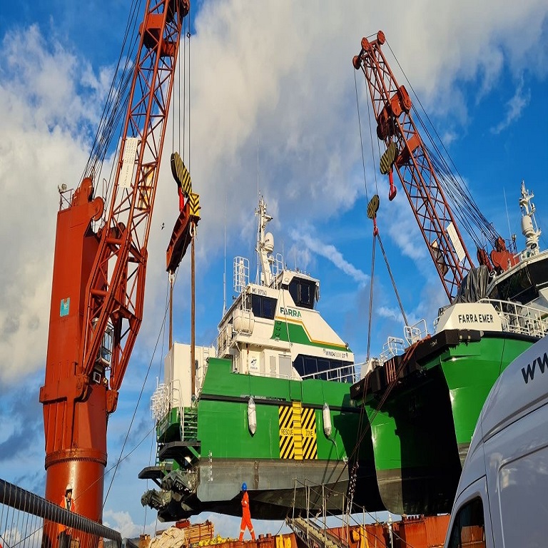 Crew Transfer Vessel being craned from the deck of BBC Dart at Port of Dover