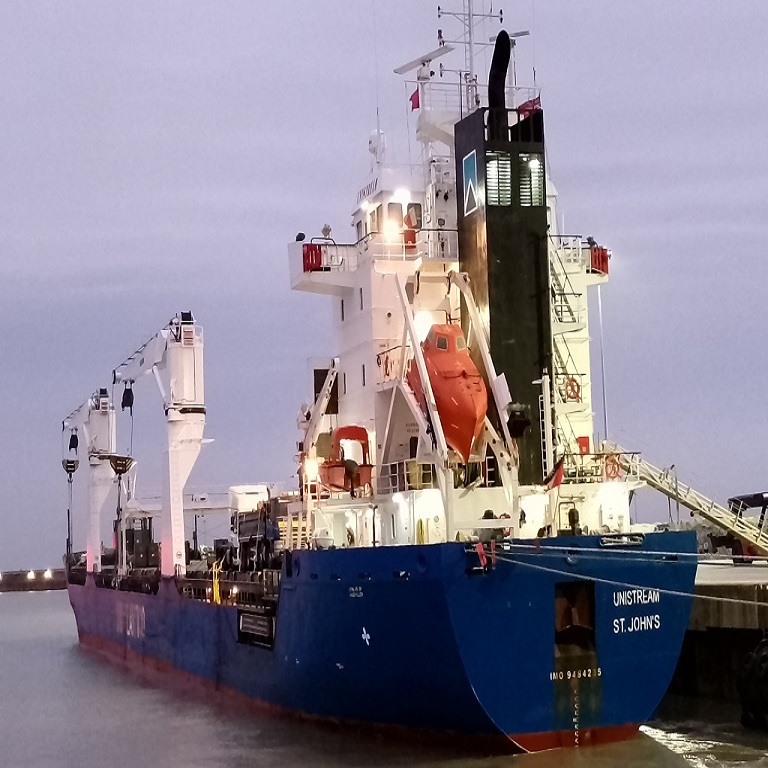 Cargo vessel Unistream moored at Port of Dover quayside waiting to be loaded with cargo of used commercial trucks.