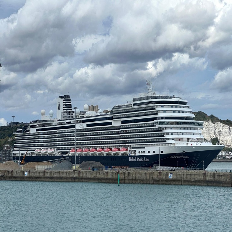 Large cruise ship berthed at Dover Port against cloudy sky